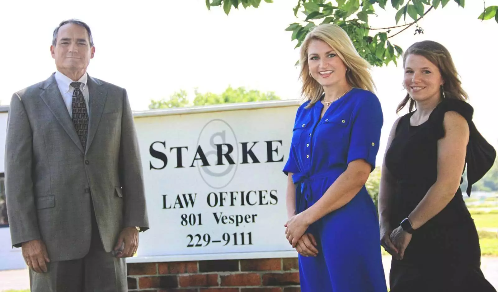 Starke Law Offices staff in front of their office building